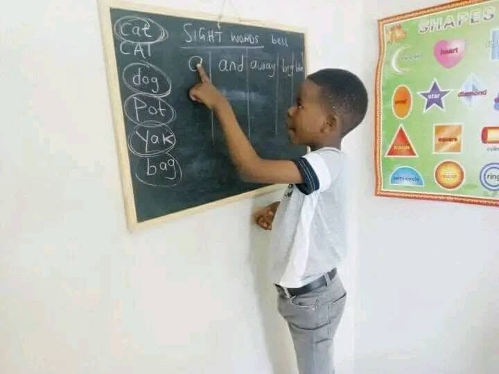 A learner writing sight words on the board